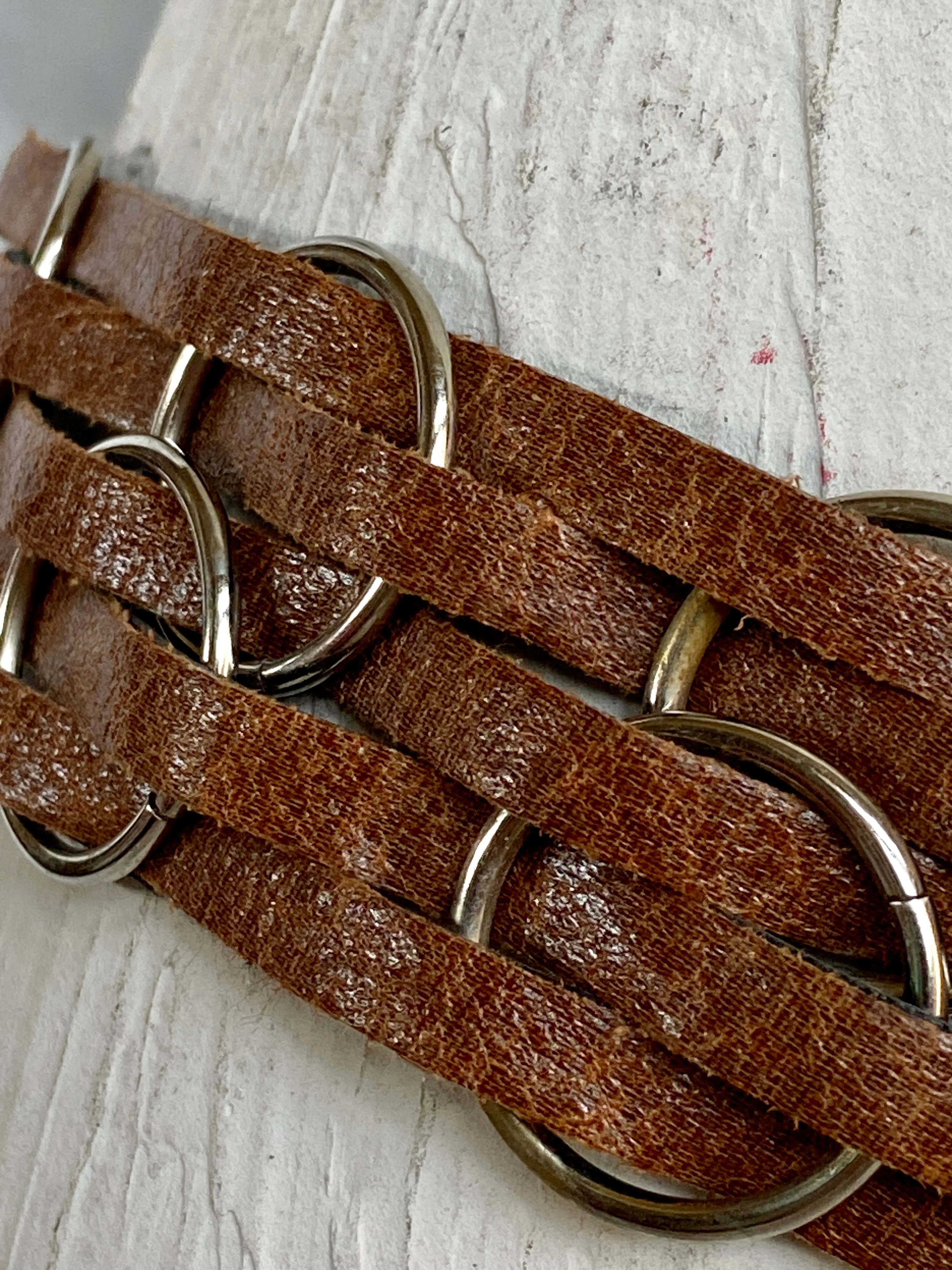 Brown leather belt with metal circle