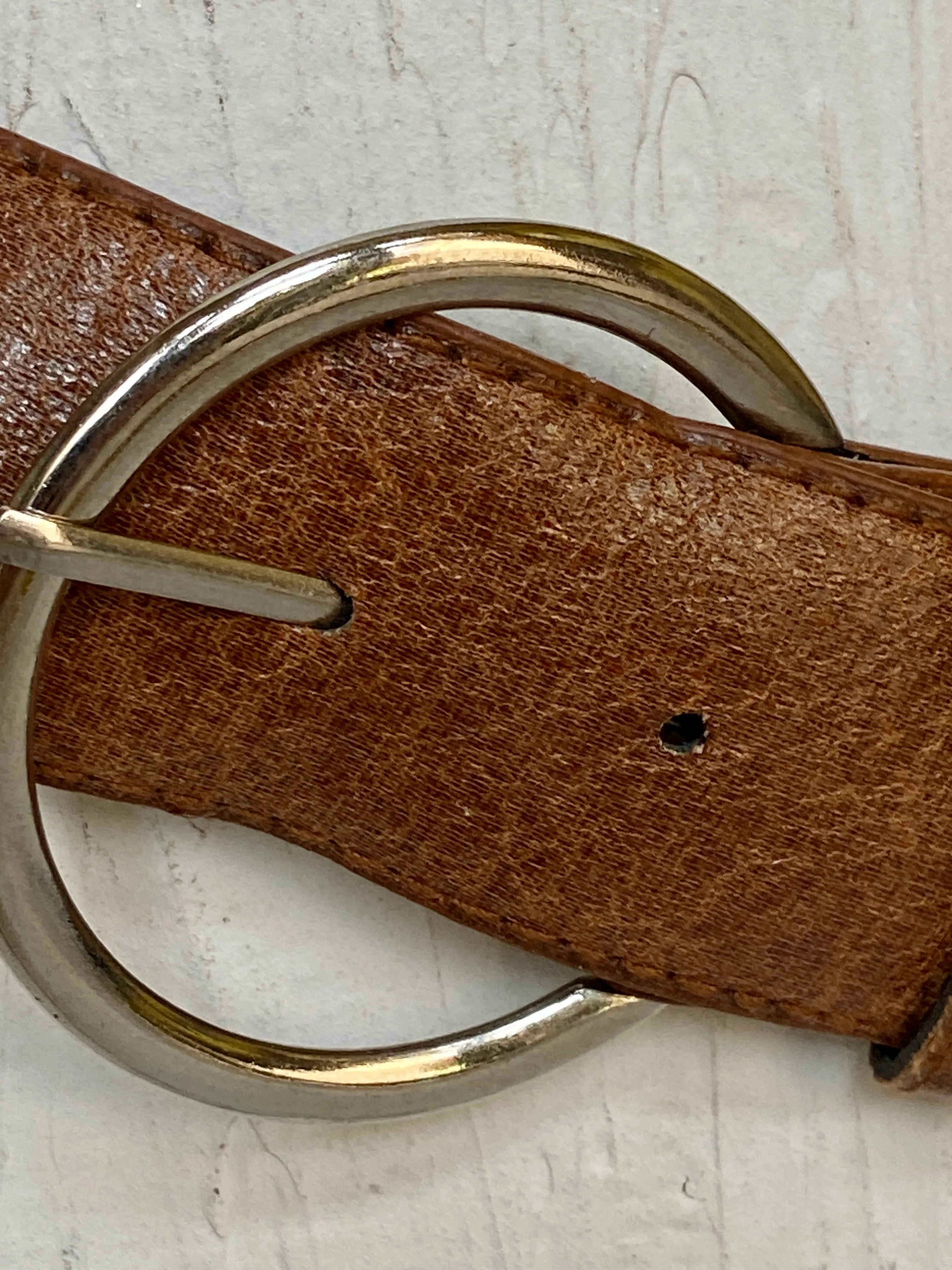 Brown leather belt with metal circle